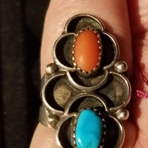 Silver ring with orange and blue stones.
