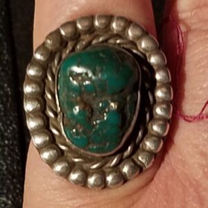 Silver ring with large turquoise stone.