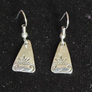 Silver earrings with sun and wave design.