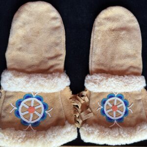 Beige mittens with blue floral embroidery.
