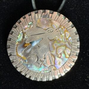 Silver rabbit pendant with iridescent background.