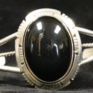 Silver bracelet with black oval gemstone.